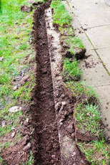 Dug out trench for repairing a broken sprinkler