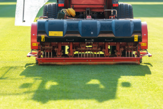 An aeration machine punching holes into a soccer field in order to promote thinker grass growth.